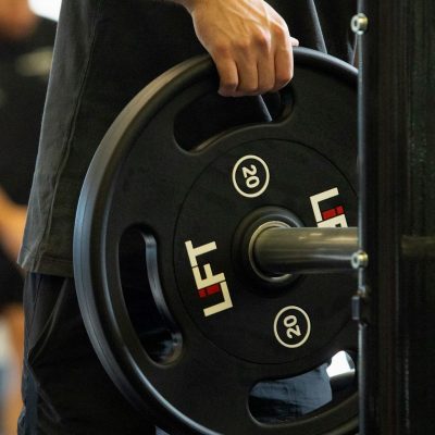 Weight Zone - Member lifting weight onto barbell